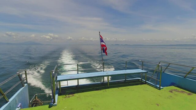 Thai Flag Blowing in the Wind on the Stern of a Ferry Crossing to Koh Phi Phi Islands from Krabi in Thailand.