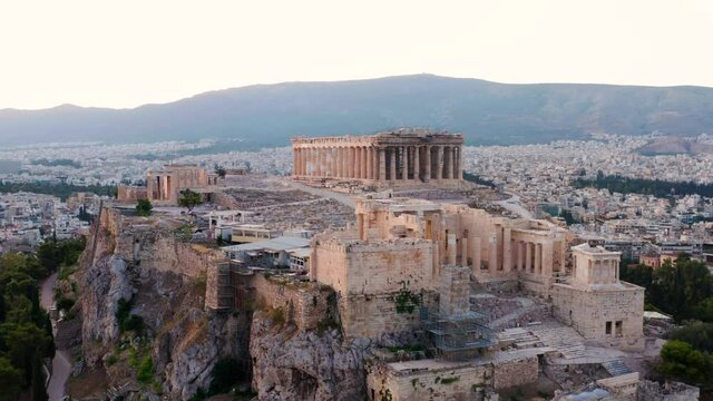Acropolis Of Athens With Historic Temples And Buildings At Sunrise Above City of Athens In Greece. - aerial