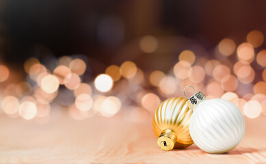 two christmas ornaments on a background of defocus lights