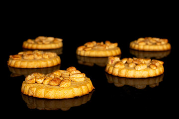 Group of six whole delicious cookie with peanuts on black glass
