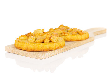 Group of two whole delicious cookie with peanuts on small wooden cutting board on white background