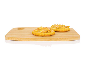 Group of two whole delicious cookie with peanuts on bamboo cutting board on white background