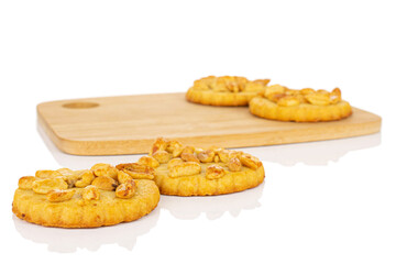 Group of four whole delicious cookie with peanuts on bamboo cutting board on white background