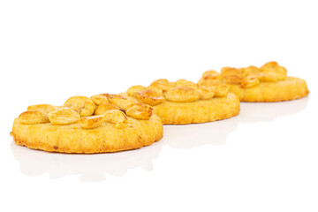 Group of three whole delicious cookie with peanuts placed diagonally on white background