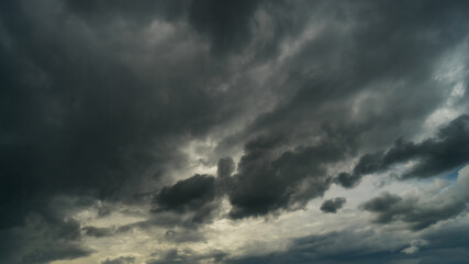Naklejka na ściany i meble Dramatic storm clouds at dark sky in rainy season