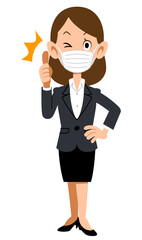 親指をたてウインクするマスクを付けてスーツを着た女性
