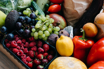 Box full of various organic berries, vegetables and fruits. Food delivery concept.