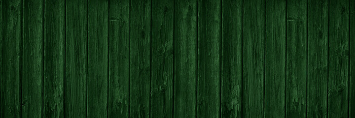 Dark green wooden background with copy space for design. Wide banner. Painted wood planks.