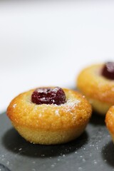 luxury hand made Micheline French modern financier with plum dessert on white black background