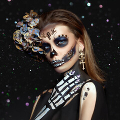 Halloween beauty skeleton woman makeup face Bokeh glitter. Girl death Halloween costume. Day of The...