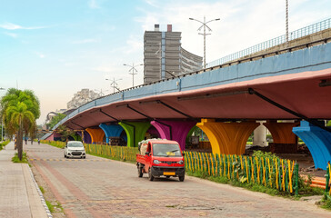 Vehicles near a city over bridge with view of commercial buildings at Kolkata India