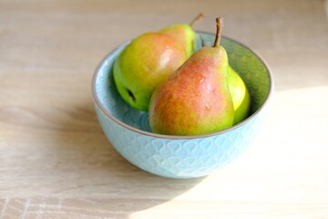 Ripe pear on the plate on wooden background . High quality photo