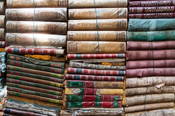 Venice, Italia - August 04 - 2021 Background wallpaper of ancient books piled on top of each other....