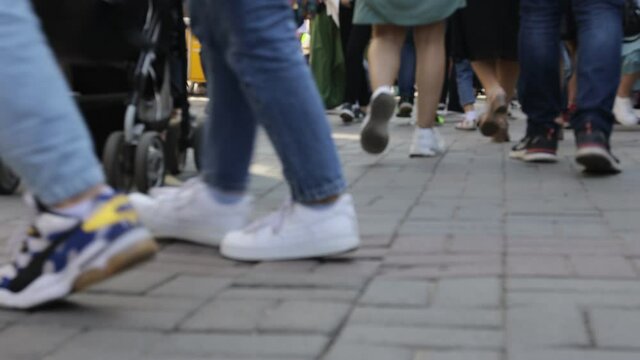 a crowd of people walking around the city for a holiday