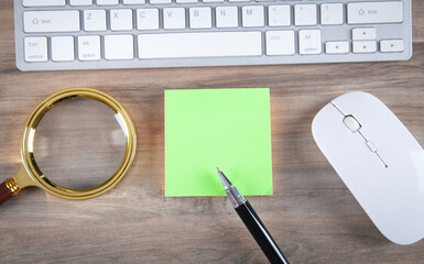 Sticky note with a keyboard and business objects.