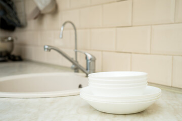 Eco friendly non-toxic cleaning dish soap with chamomile flowers, clean white plates