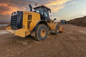 Excavator moving dirt and sand at a construction site
