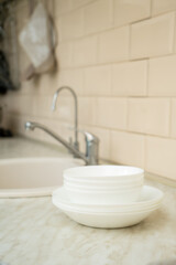 Eco friendly non-toxic cleaning dish soap with chamomile flowers, clean white plates