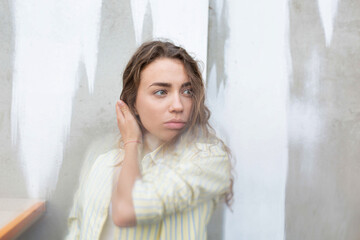 Fototapeta premium White girl with hand near the face partially white background