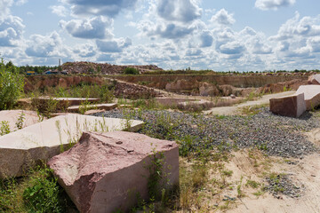 Large blocks of red granite with flat and torn edges