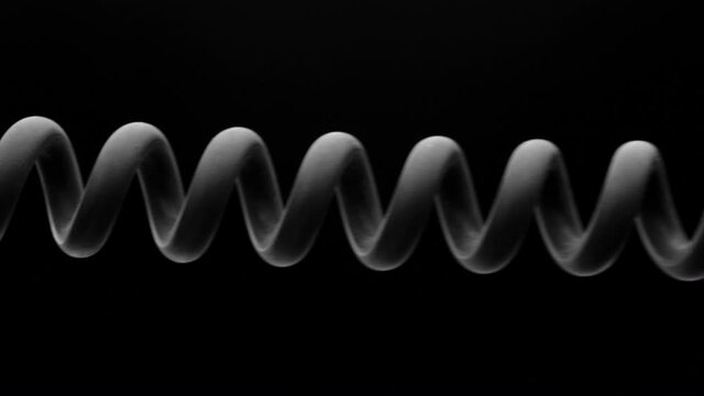 Spring is compressed and expanded against a black background.