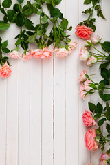 Pink roses on a light wooden background,