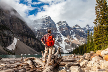 Hiking Man Looking at Moraine Lake and Rocky Mountains, Canada