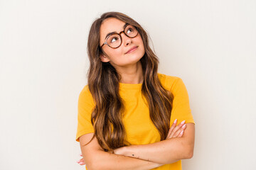 Young caucasian woman isolated on white background dreaming of achieving goals and purposes