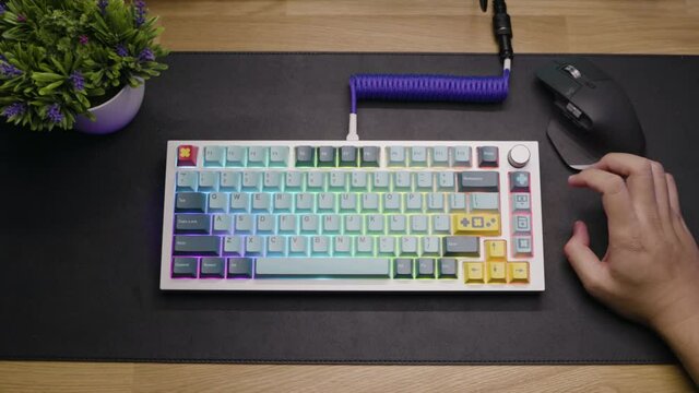 A footage of a man assemble a DIY premium custom keyboard build kit with full alluminium base and bright RGB LED Colors