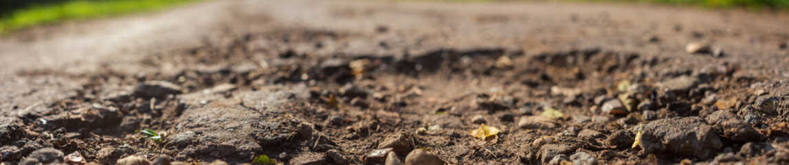 Panorama of a country road with a pit close up