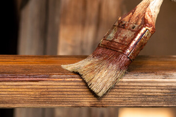 close-up of the brush, which is applied a special composition to the wood to prevent its rotting