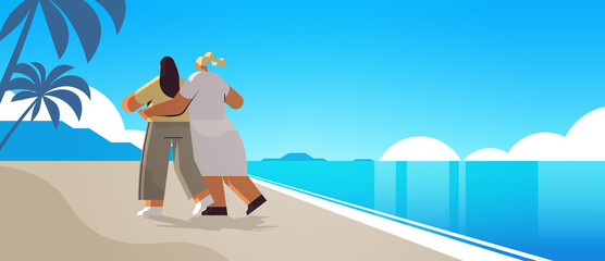 two girls hugging on beach gay lesbian love parade pride festival transgender love concept seascape background