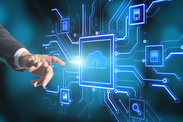 Businessman hand pointing at abstract glowing circuit cloud computing interface on blurry blue bokeh background. Information, technology and network concept.
