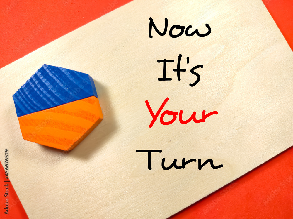 Fototapete business concept.text now it's your turn writing on wooden board with colored block on red backgroun