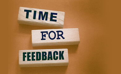 Time fir feedback text on wooden blocks. Product or service evaluation and clients feedback in...
