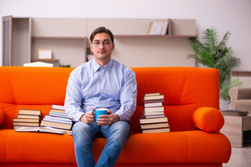 Young male student preparing for exams at home