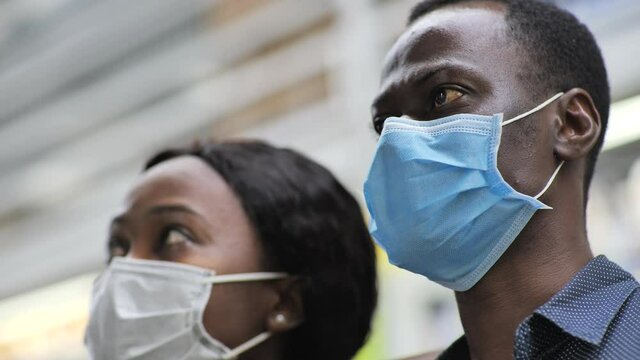 Woman with boyfriend discuss goods in supermarket. African couple in face mask,close up of facial expressions of they look products quarantine and self-isolation,epidemic covid-19,coronavirus pandemic
