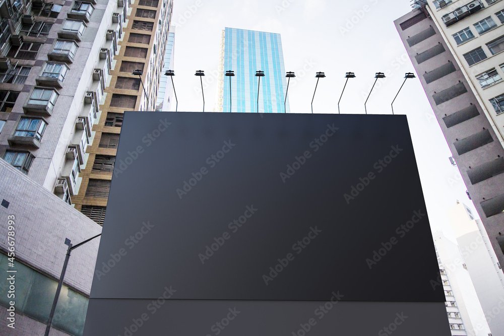 Poster empty black billboard in city with bright sky and daylight. advertisement and commercial concept. mo