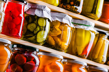 Jars with variety of marinated vegetables and fruits