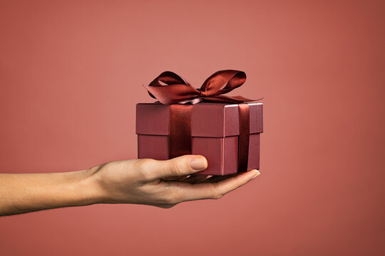Woman hand holding elegant gift box