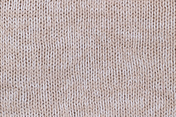 Beige texture of knitted wool sweater. Hand knitting.