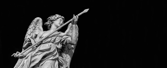 Angel statue holding the Holy Lance of Longinus. A 17th century baroque masterpiece at the top of Sant'Angelo Bridge in the center of Rome (Black and White with copy space)