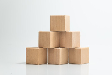 Pyramid of six wooden cubes, on white background