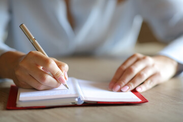 Woman hands handwriting on paper agenda