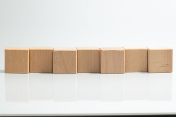 Pyramid of seven wooden cubes, on white background