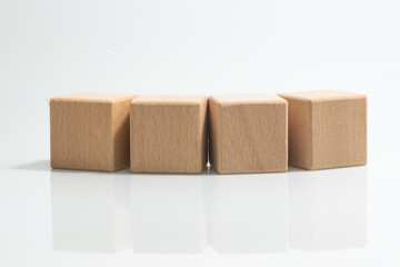 Pyramid of four wooden cubes, on white background