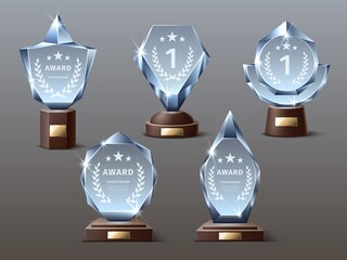 Glass award trophy. Realistic crystal prize trophies with engraved inscriptions, acrylic mockups, transparent sparkling figures. Vector set