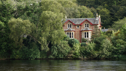 Fototapeta na wymiar house on the river, River Ness, Ness islands, Iverness, Scotland