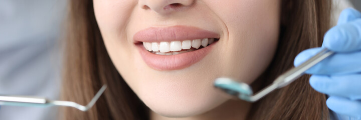 Portrait of woman with white beautiful teeth at dentist appointment