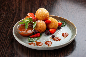 Caramel and strawberry curd balls. Dessert. On a wooden background